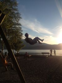 People on beach against sky