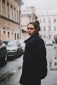 Woman standing on street in city during winter