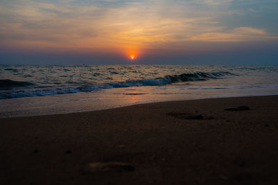 Scenic view of beach against sky during sunset