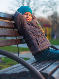 Portrait of girl sitting on bench