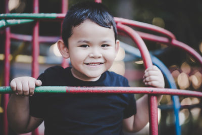 Portrait of smiling boy playing at playground