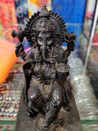 Close-up of buddha statue against building