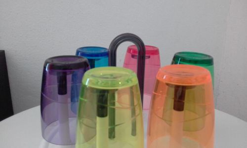 Close-up of multi colored bottles on table