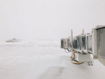 Snow on train against sky during winter