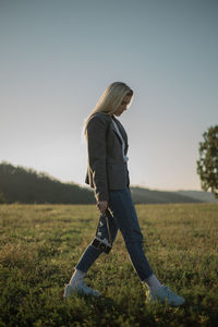 A young woman holding a vintage camera