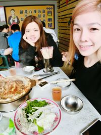 Portrait of a smiling young woman eating food