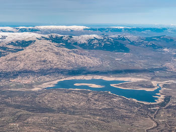 Aerial view of snowcapped mountains against sky