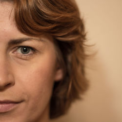 Close-up portrait of woman against wall