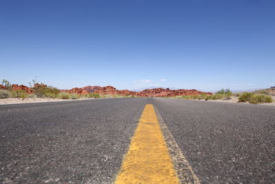 Surface level of road against blue sky