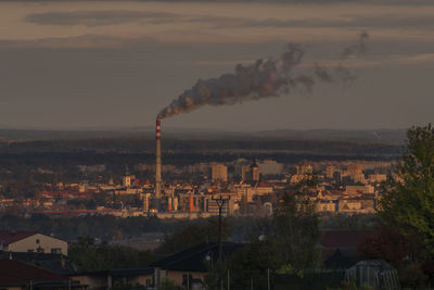 Smoke emitting from chimney against sky
