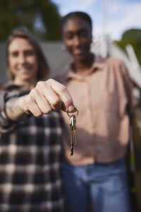 Smiling women holding house keys