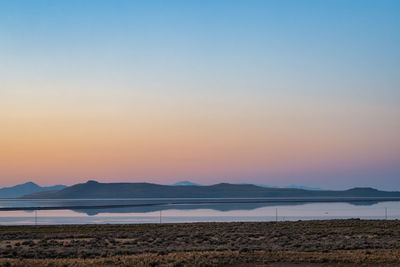 Sunrise over the great salt lake in utah. mountain reflection in calm water.