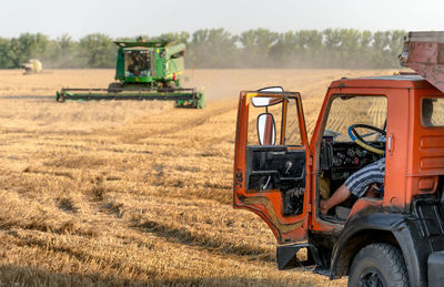 Low section of man in truck on farm