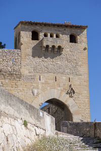 Low angle view of historical building against blue sky