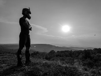 Full length of man standing on field against sky