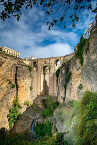 View of arch bridge against cloudy sky