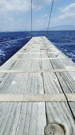 Surface level of pier over sea against sky