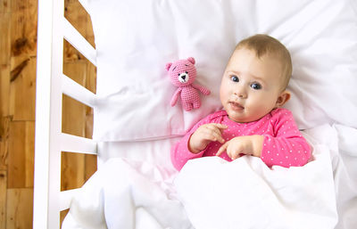 Portrait of cute baby boy sleeping on bed at home