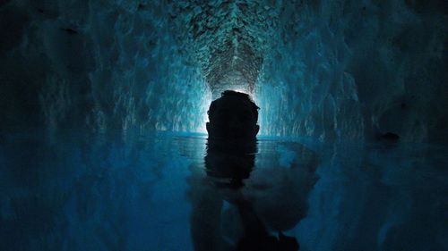 Silhouette woman standing in swimming pool