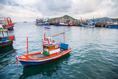 Boats moored in sea against sky