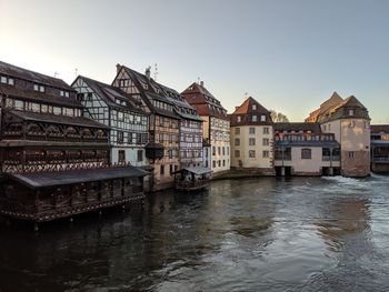 Traditional alsatian buildings by a river in the old town of strasbourg, france.