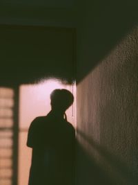 Man standing against wall in building