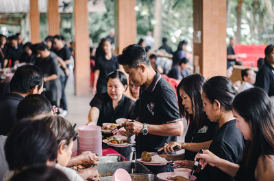 Group of people eating food at restaurant