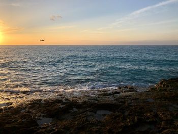 Scenic view of sea against sky during sunset