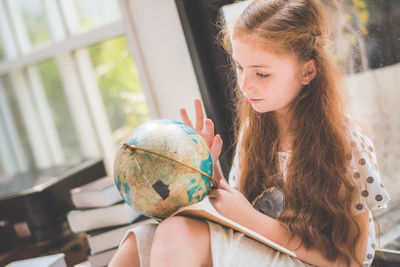 Girl looking at globe