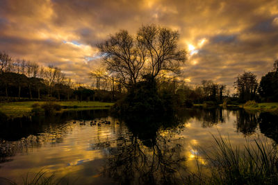 Scenic view of lake against cloudy sky