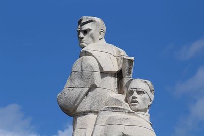 Low angle view of statue against blue sky