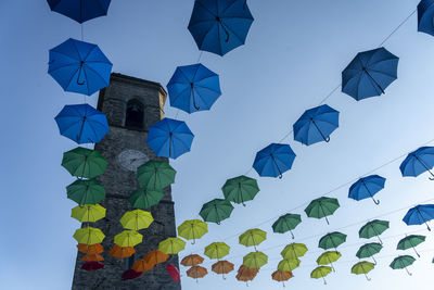 Low angle view of decoration hanging against clear blue sky