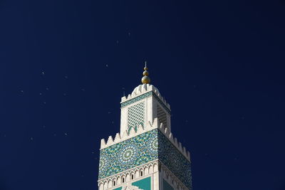 Low angle view of illuminated building against clear sky