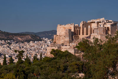 Buildings in city against clear sky
