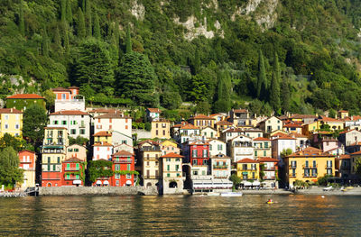 Calm lake against built structures on landscape