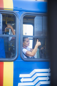 Man standing by train window