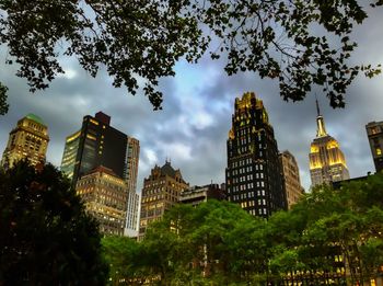 Low angle view of buildings against cloudy sky