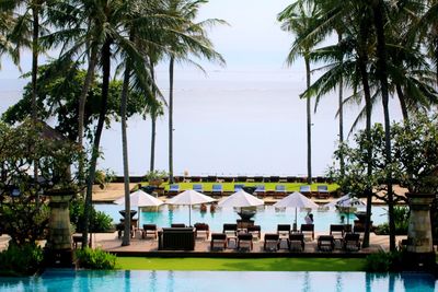 View of swimming pool by sea against sky