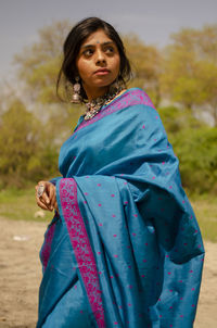 Portrait of beautiful woman lying on land