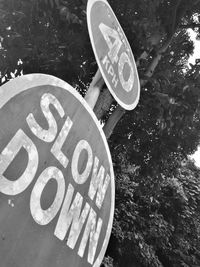 Close-up of signboard against trees