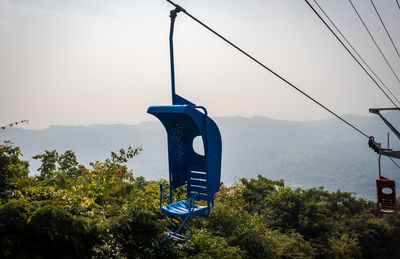 Overhead cable car against sky