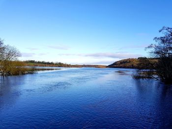 Scenic view of lake against blue sky