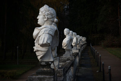 Statues in row at park