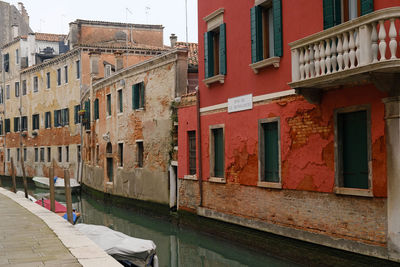 Typical narrow street with historical houses between the canals in venice, italy.