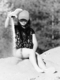 Midsection of woman sitting on land