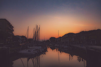 Sailboats in marina at sunset