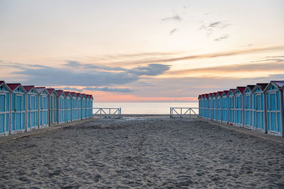 Scenic view of beach against sky during sunset. little blue houses on the beach