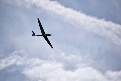 Low angle view of airplane flying in sky