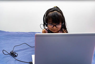 Cute girl using laptop at home