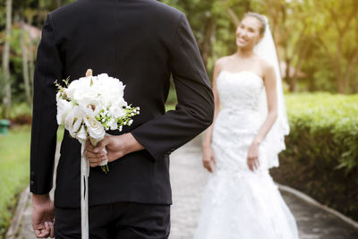 Rear view of couple holding hands